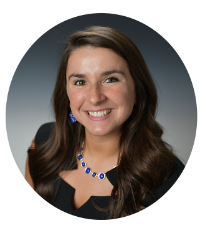 Headshot of Kentucky Farmers Bank Loan Officer. She is smiling, and wearing a black dress with a blue necklace against a grey background.